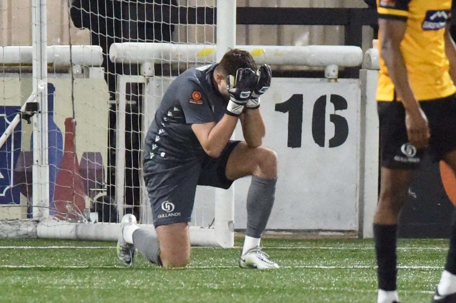 Head in hands for Tom Hadler after Bromley's injury-time winner. Picture: Steve Terrell