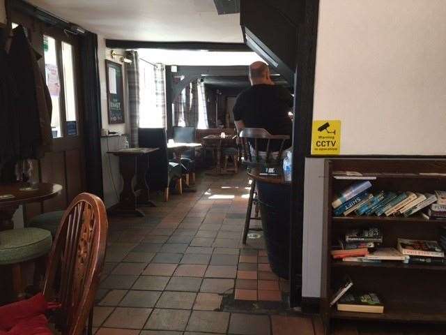 It's a traditional village pub with beams, old beer steins, dark brown furniture and a quarry-tiled floor