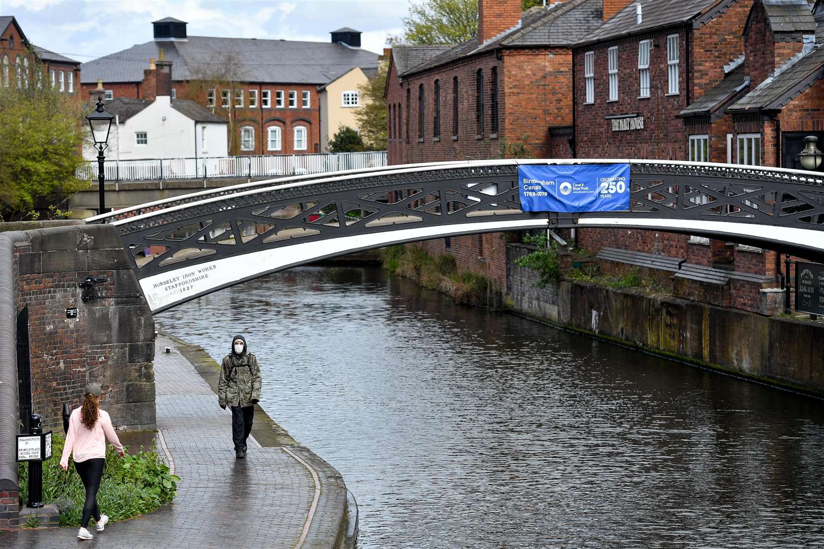 People walking along the canal-side in Birmingham city centre. (Jacob King/PA)