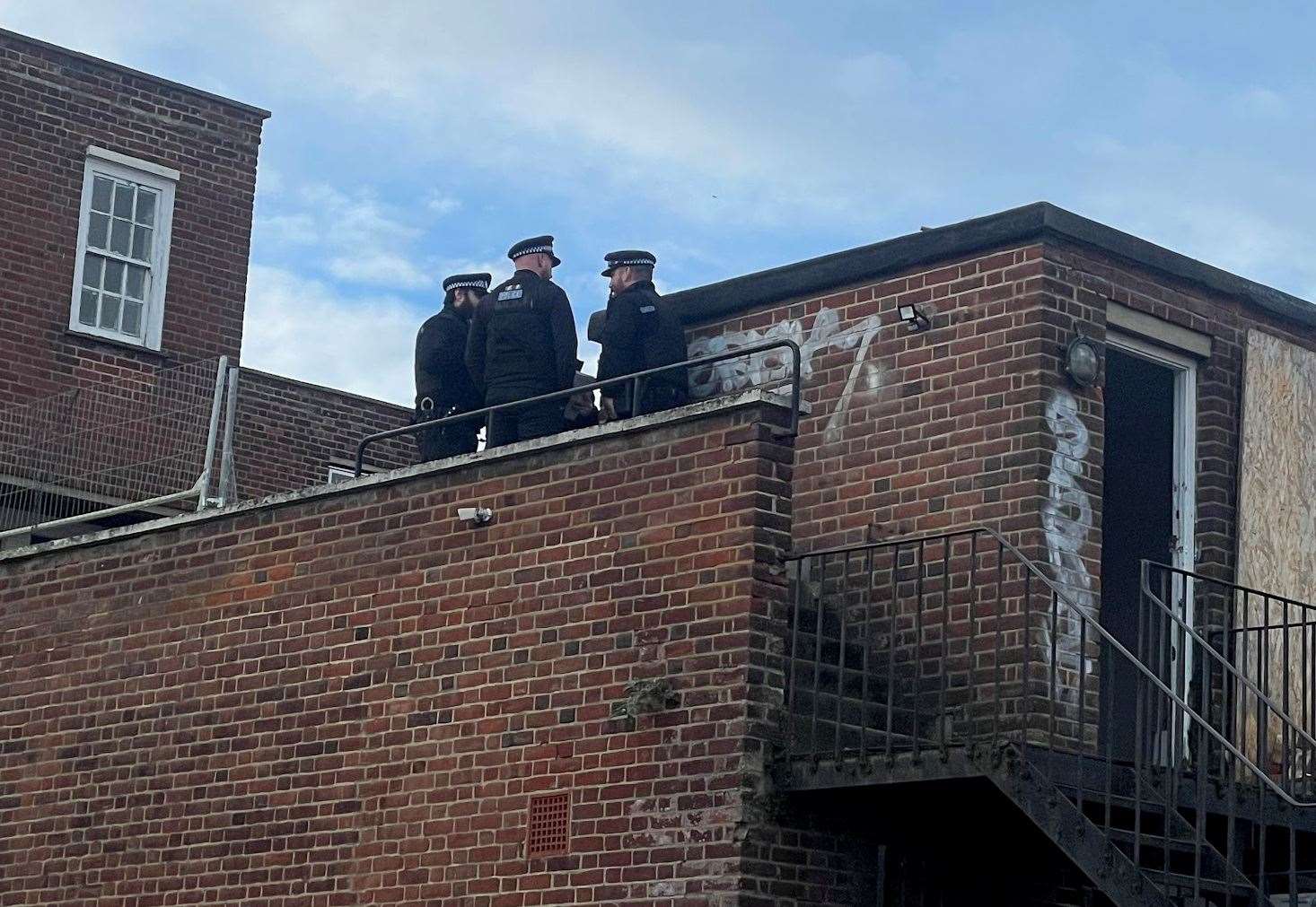 Officers were spotted on the roof of the building