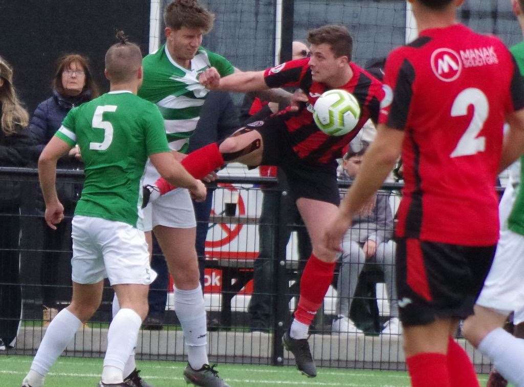 Erith Town (red) and Corinthian get to grips with each other on Good Friday. Picture: John Anderson corkyboy@gmail.com