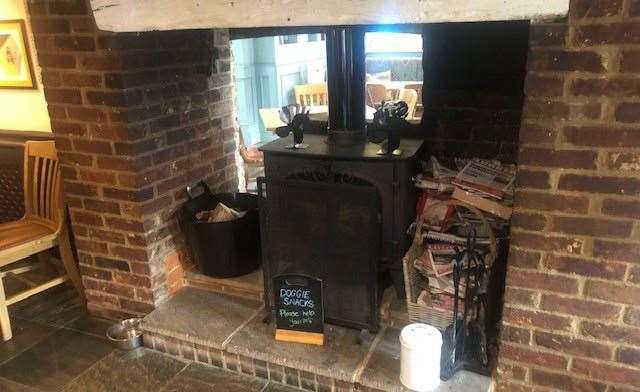 As I took this shot of the wood burner in the fireplace, complete with its sign for free doggie snacks, I realised I took an almost identical photograph last time I was in