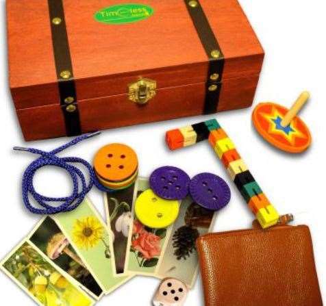 The Curiosity Box features picture cards, a spinning top, buttons and twisting blocks