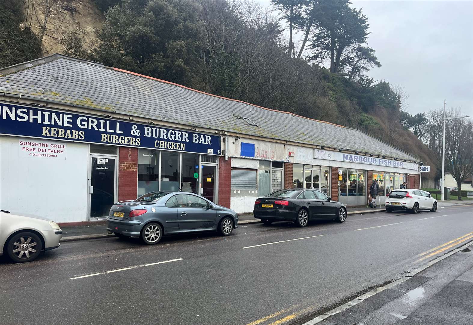 A parade of shops on Lower Sandgate Road where the Harbour Fish Bar remains open after only experiencing minimal damage in the recent landslides.