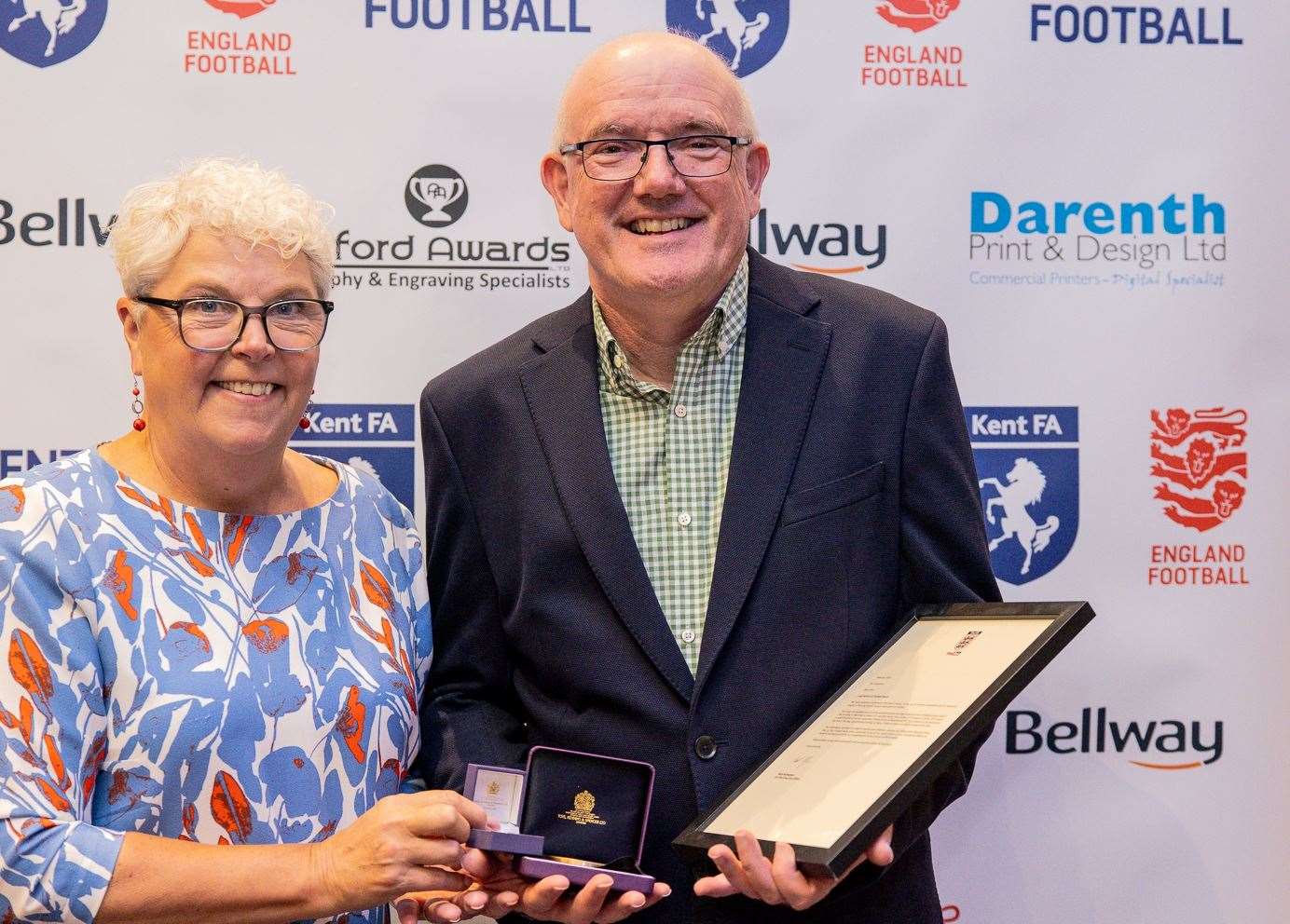 Geoff Lawrence collects his award on behalf of dad John Lawrence from Kent FA chair Denise Richmond. Picture: Kent FA