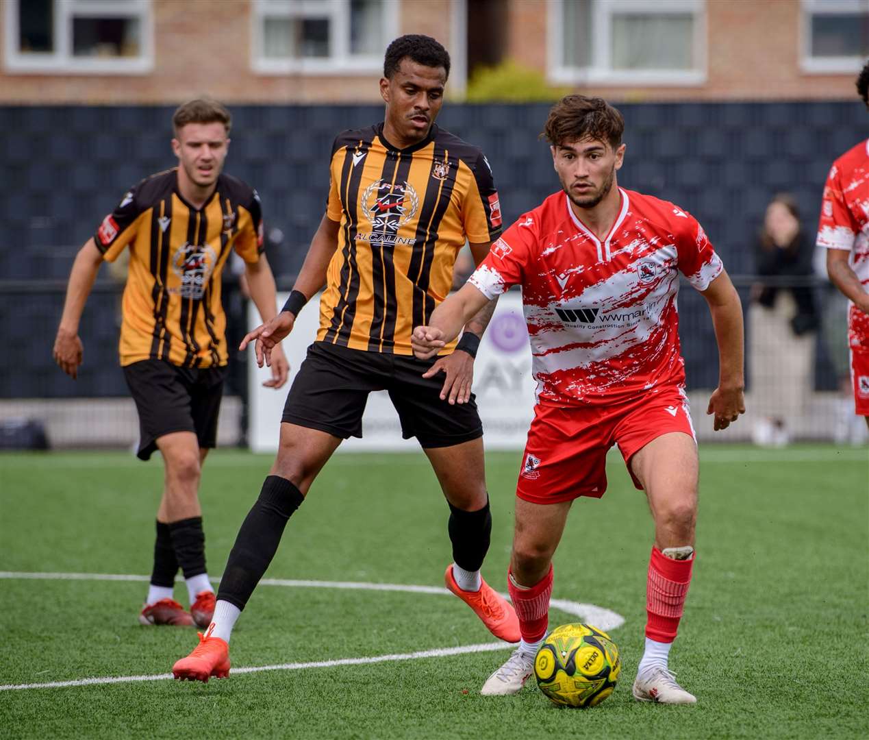 Ramsgate’s first-half scorer Lewis Gard takes on Folkestone defender Jamie Mascoll in Invicta’s 3-1 FA Cup first qualifying round defeat on Saturday. Picture: Stuart Watson