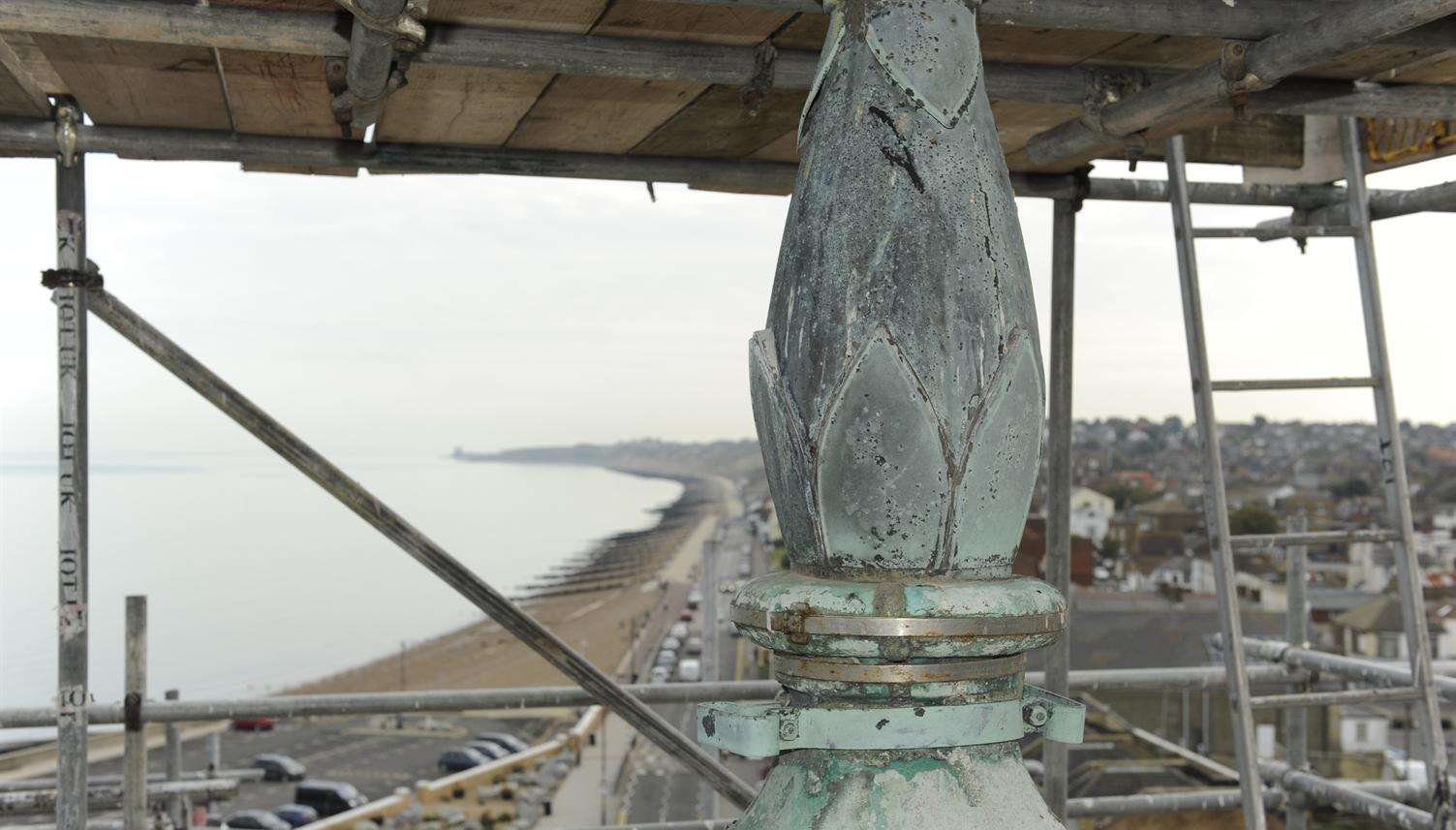 The top the the bell tower with the coast in the background