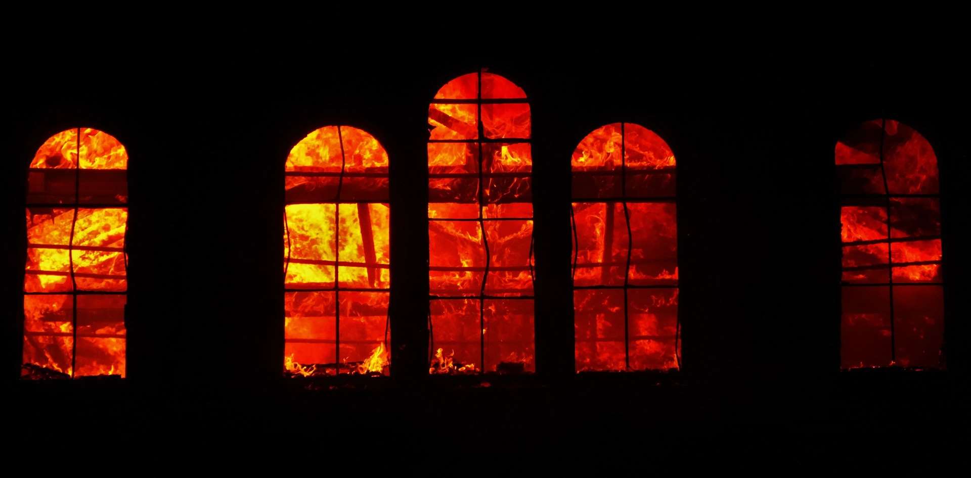 Flames behind the windows of the blazing water tower in Trinity Road, Sheerness. Picture: Phil Crowder