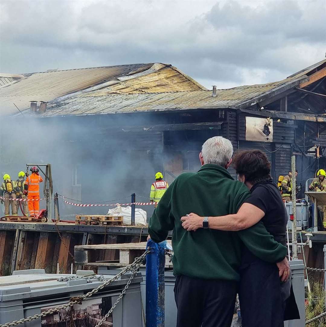 Crab and Winkle Restaurant owners Peter and Elizabeth Bennett as they watch the fire at the cockle shed in Whitstable harbour engulf their business. Picture: Charlotte Rose Nash