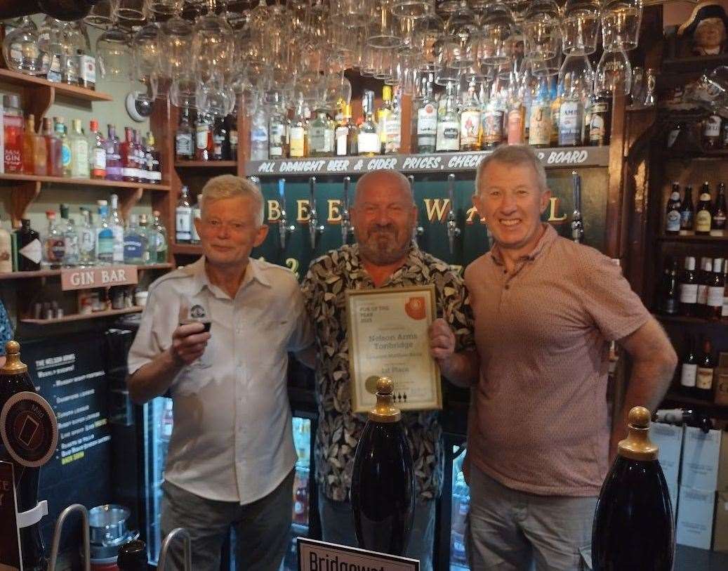 Landlord Matthew Rudd, centre, with the regional award. Picture: