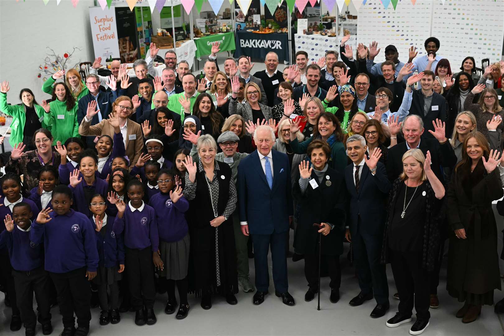 Charles and London Mayor Sadiq Khan pose for a group photo at the Coronation Food Project hub in Deptford, south-east London (Justin Tallis/PA)