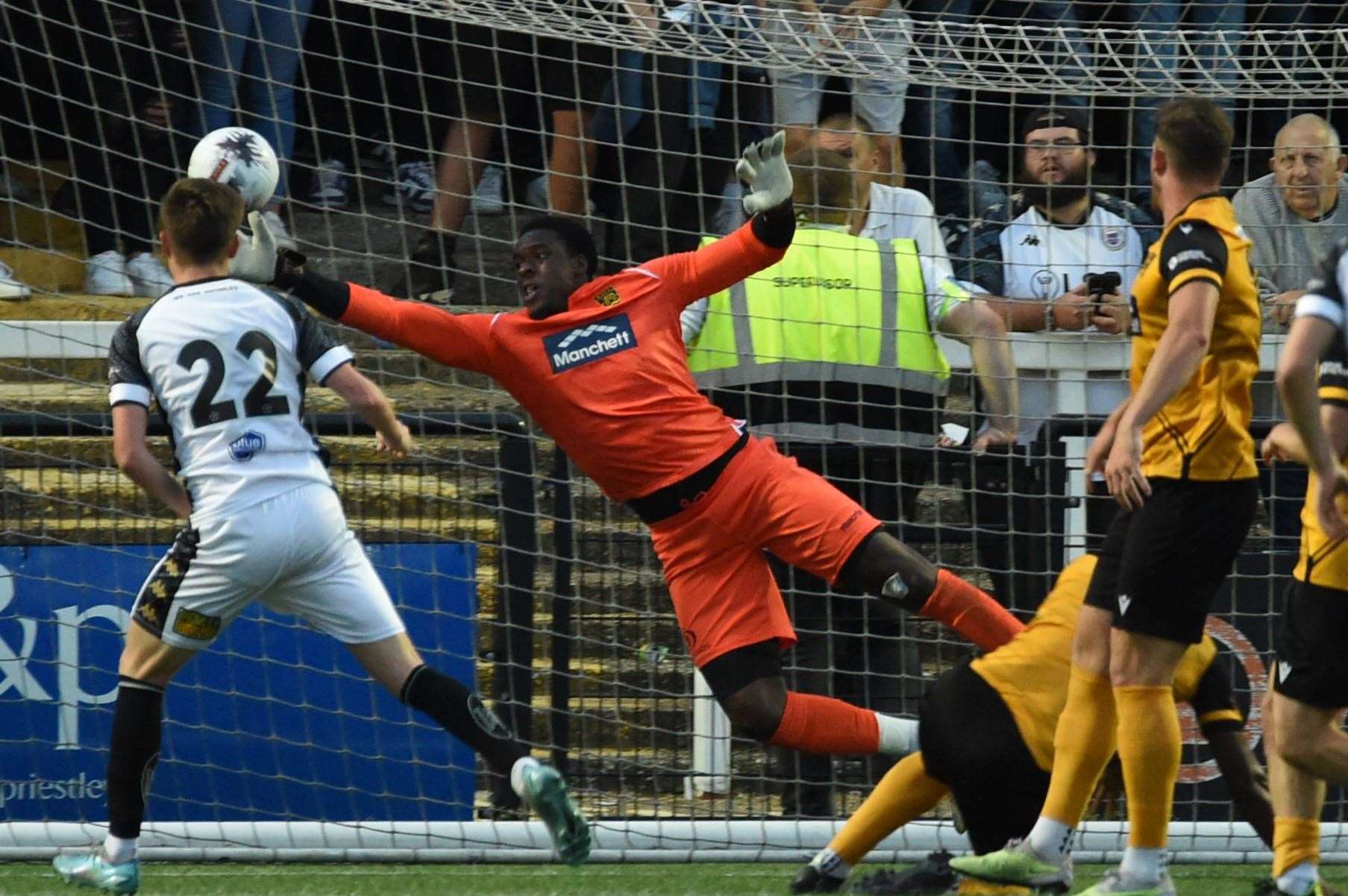 Maidstone’s trialist goalkeeper pulls off a decent save at Bromley. Picture: Steve Terrell