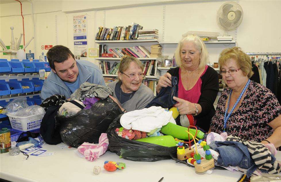 Volunteers Gary Sims, Janey DeSouza and Sheila Brown help manager Pat Gibbs unpack donated goods at the Ashford PDSA shop in New Rents