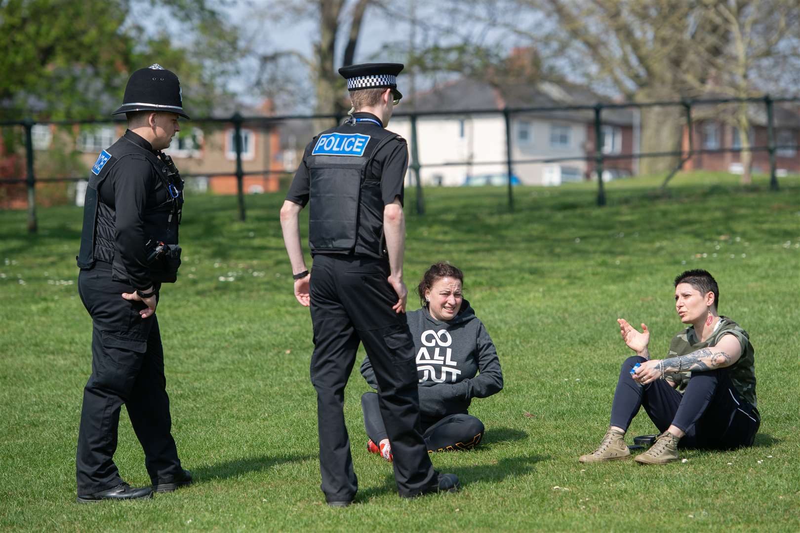 Officers talk to members of the public at a park in Northampton, as police announce they are toughening up their social distancing enforcement (Joe Giddens/PA)