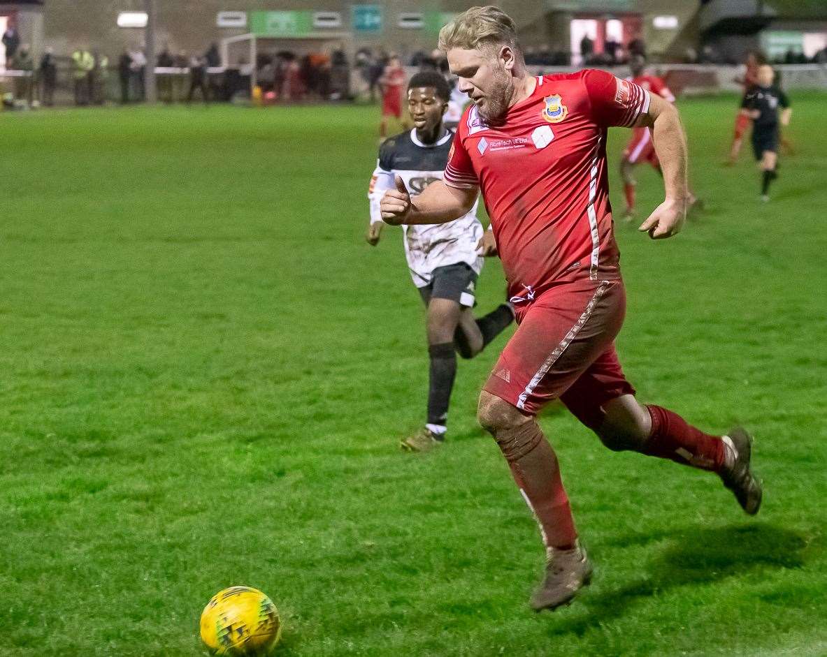 Striker Harry Goodger drives down the left for Whitstable, with Faversham's Donvieve Jones in pursuit. Picture: Les Biggs