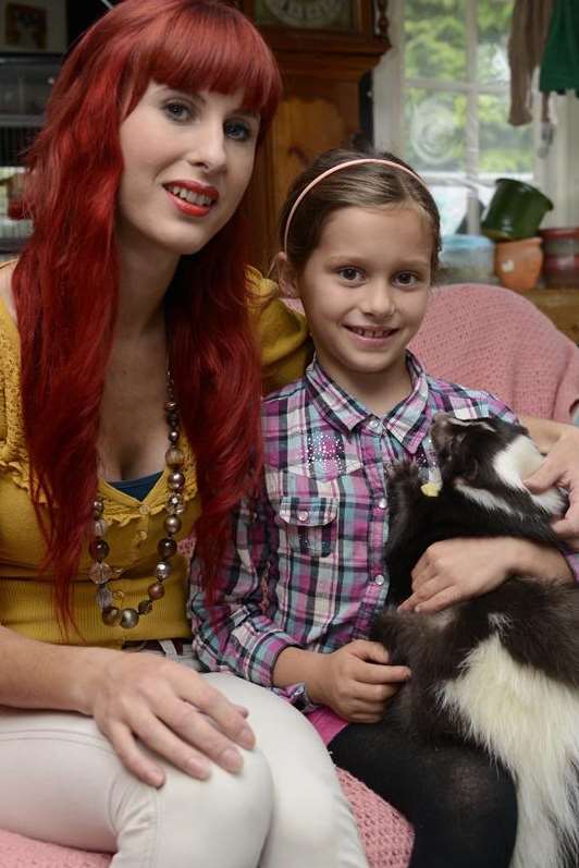 Maria Cooper with daughter Harriet and Humbug the skunk