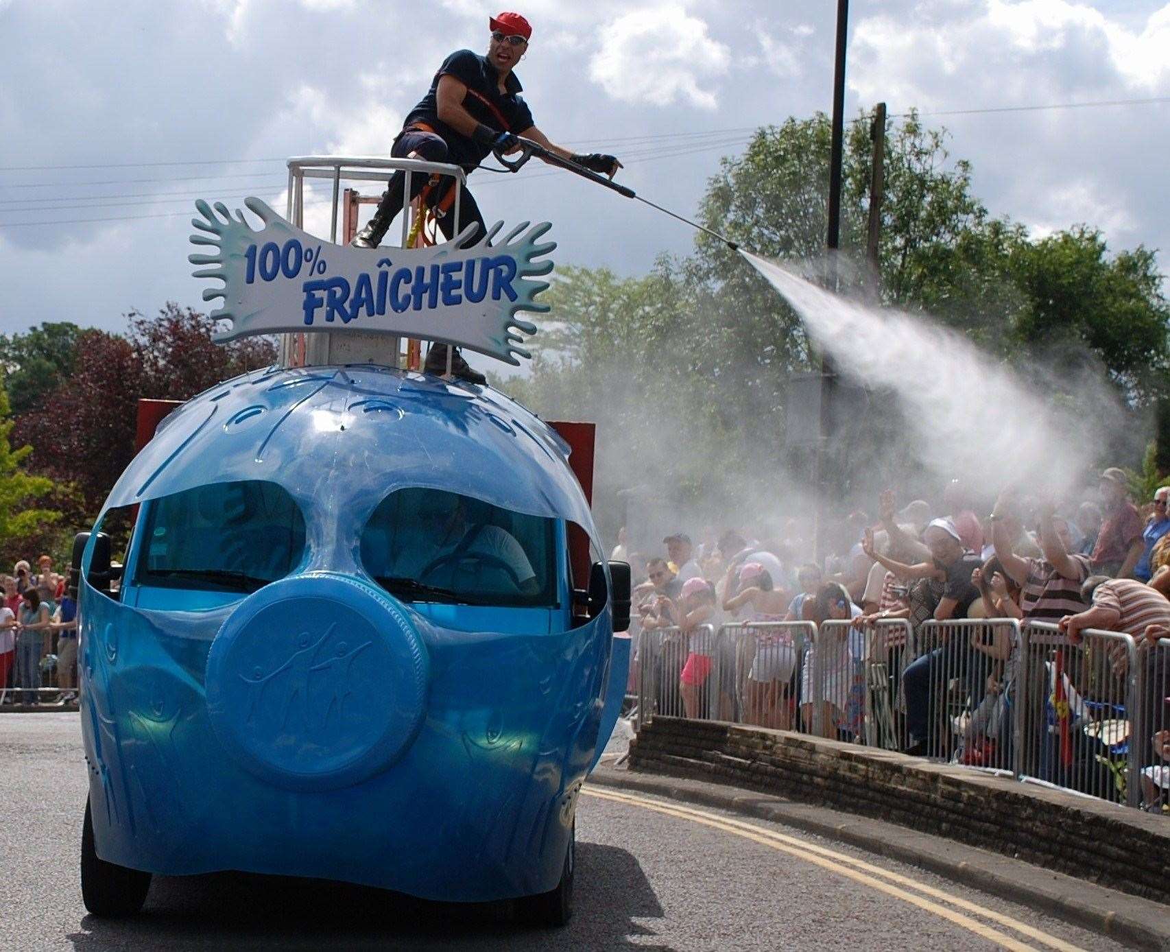 Hot spectators given a helpful shower before the riders arrived. Pic: Bob Goodwin