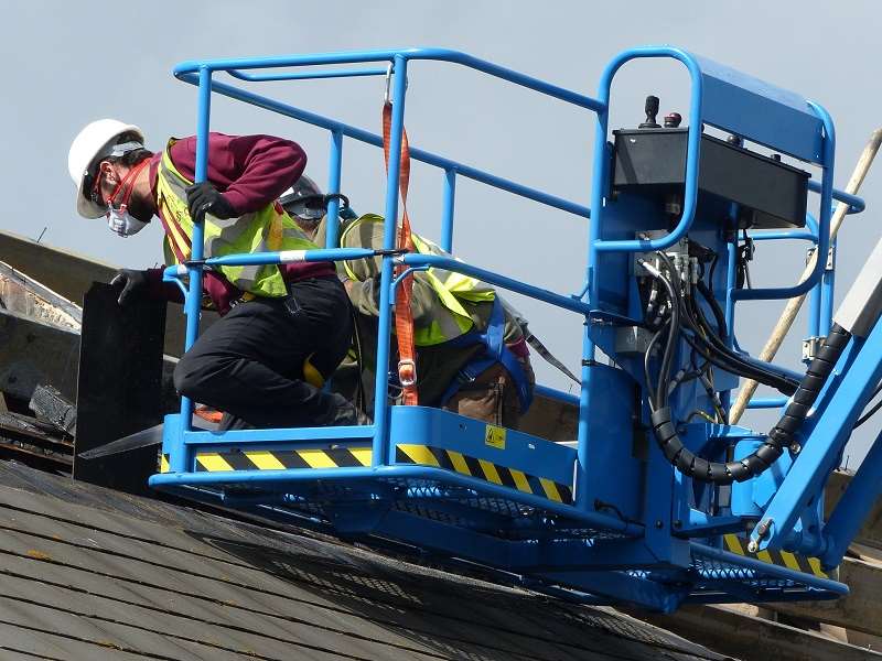 Workmen inspect the fire-damaged roof of the Tesco Express in Mace Lane, Ashford Picture courtesy: Andy Clark