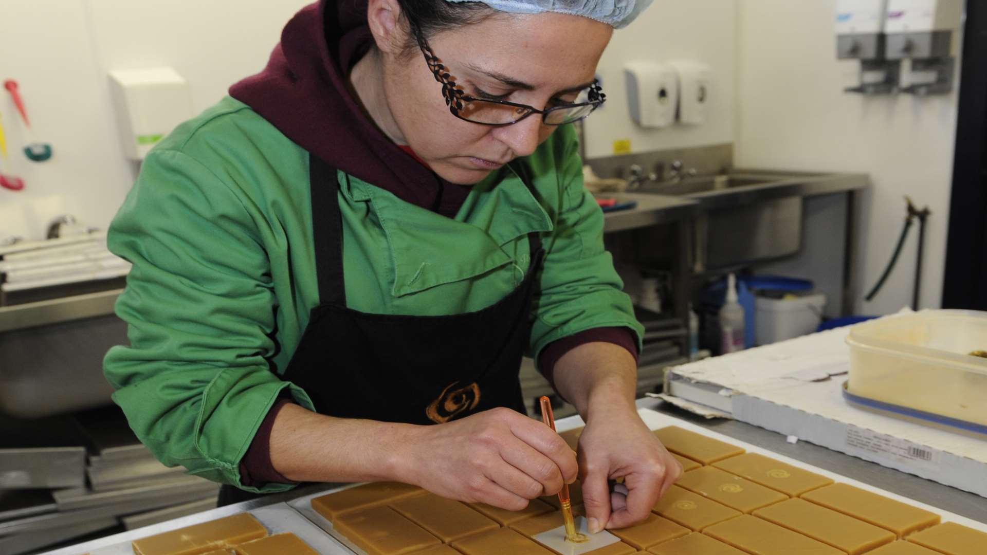 Tania Silva adds a stencil to the fudge