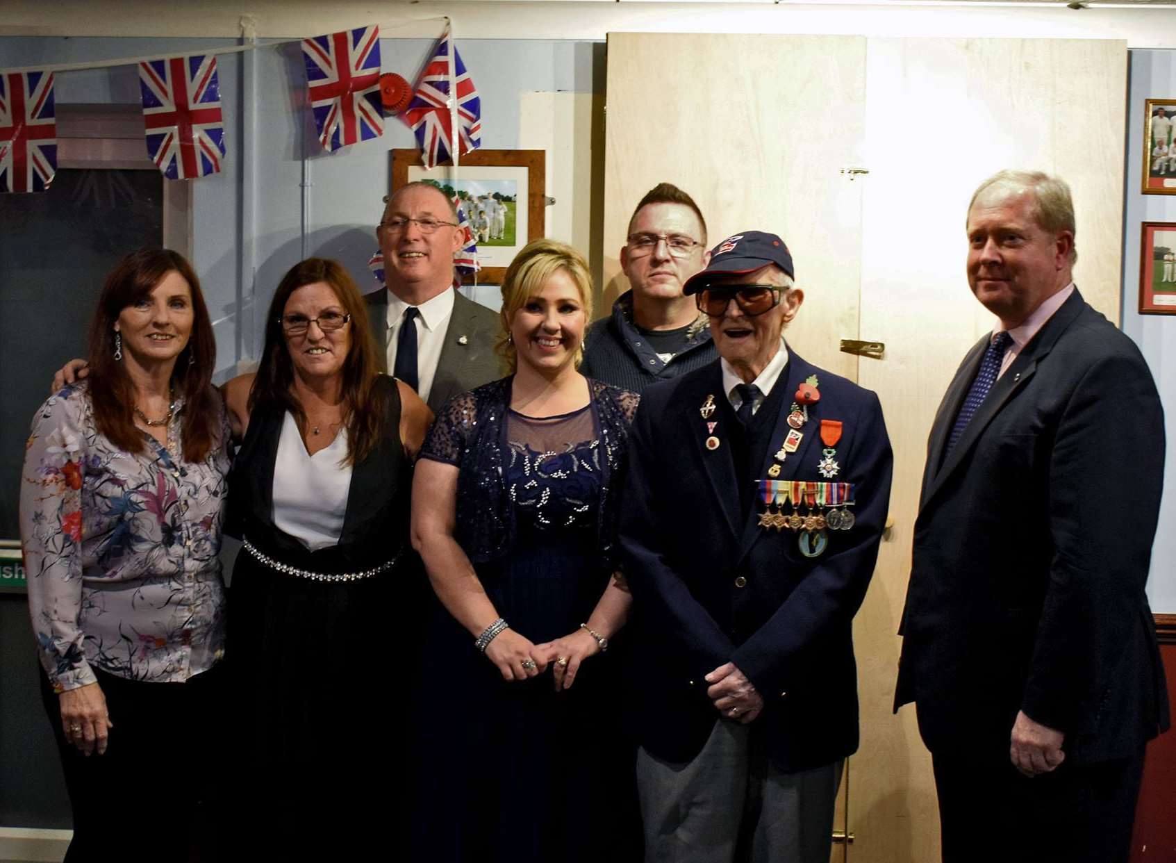 Cedric and his children Anne Bourne, Jennifer Kellum, Kim Hollands, Tracey Wretham, John Hollands, with the French consulate representative James Ryeland