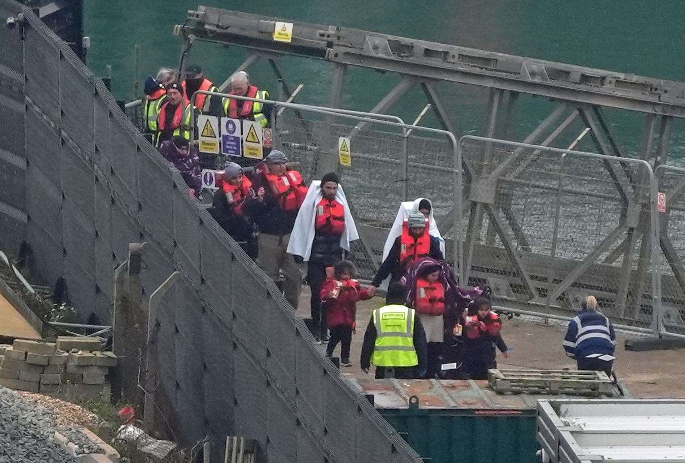 A group of people thought to be migrants, including young children, are brought in to Dover, Kent, from a Border Force vessel (Gareth Fuller/PA)