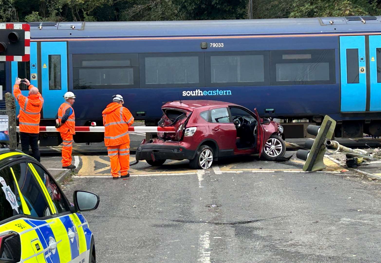 Images show emergency crews working at the site where a train hit a broken-down car at the Grove Ferry level crossing, near Hersden