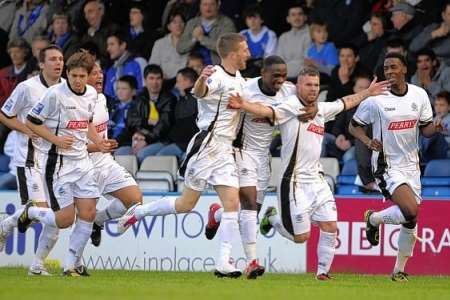 Adam Birchall celebrates with team mates after scoring the opening goal for Dover