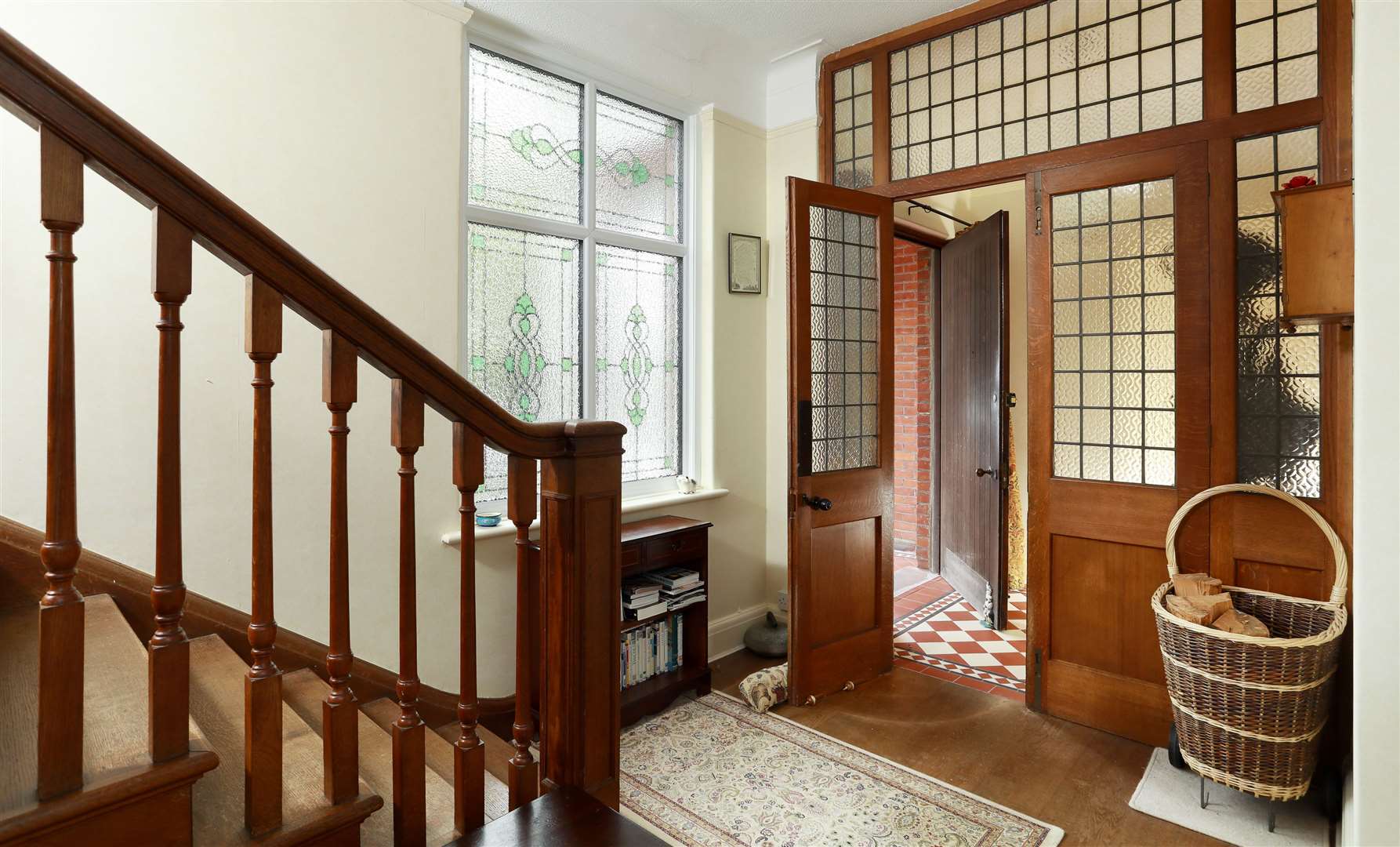 Oak and glass doors from the porch lead to the hallway