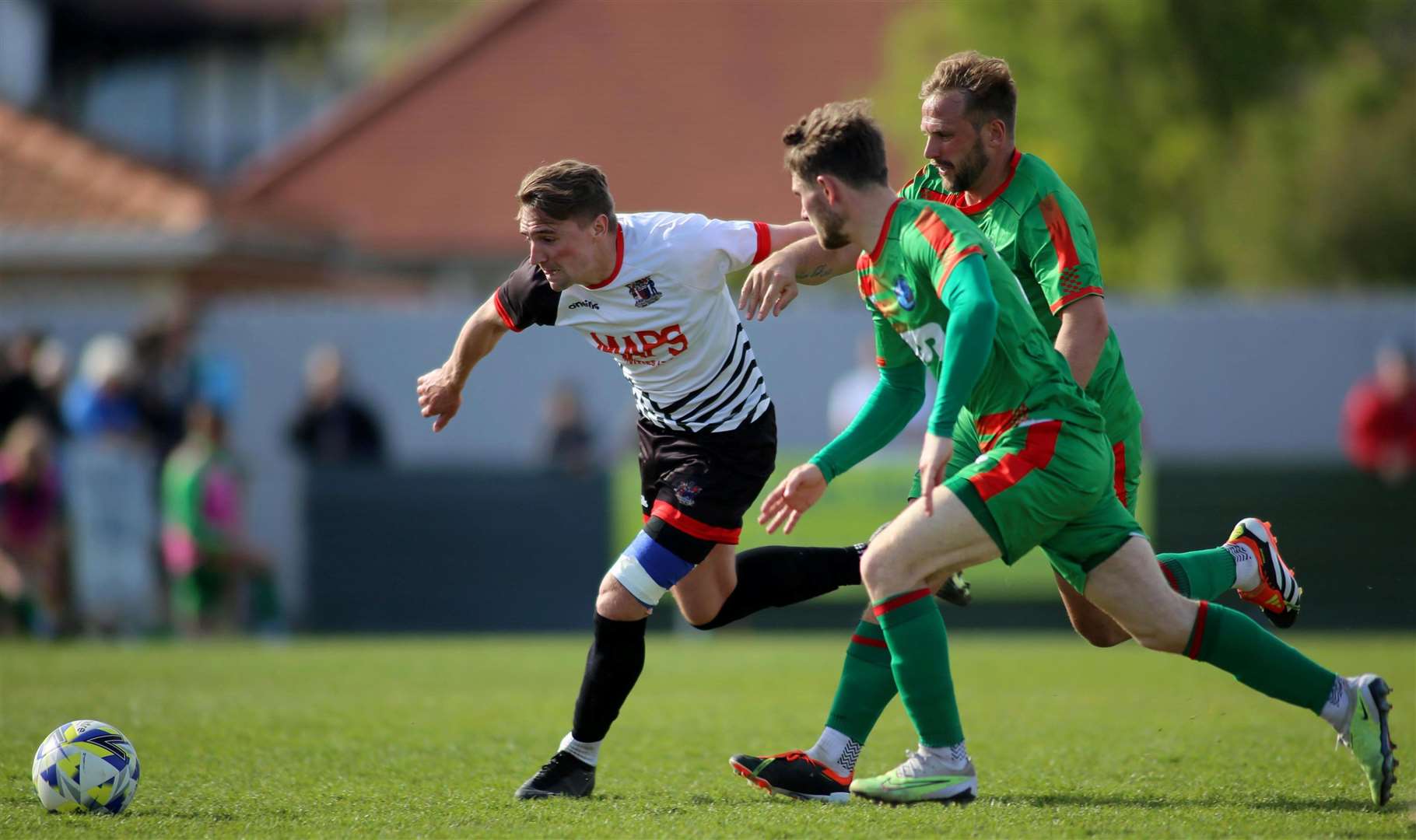 Deal's Tom Chapman tries to take on Lydd's Kane Penn as he starts to move away from another Lydd Town player. Picture: Paul Willmott