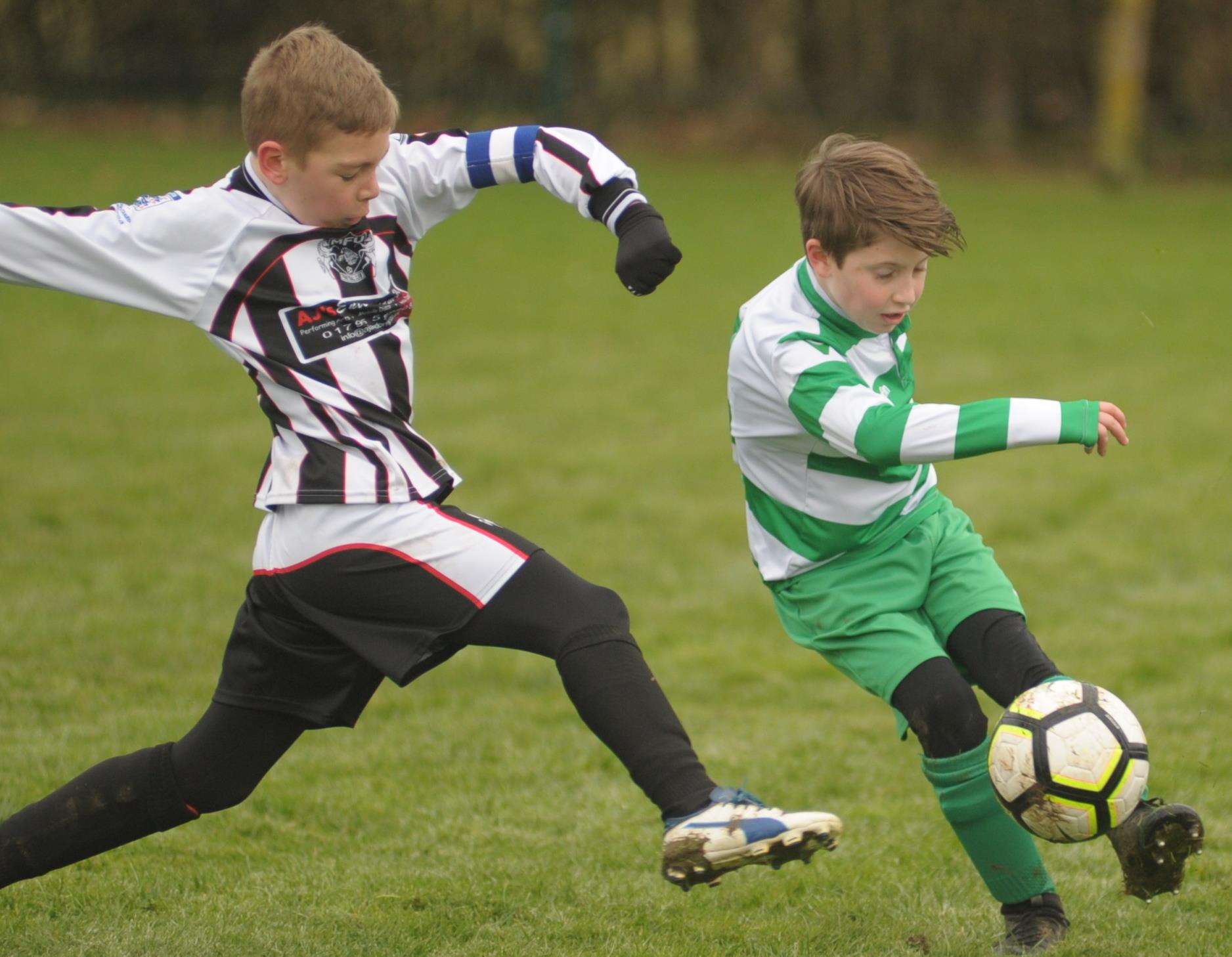 New Ash Green under-10s are put under pressure by Milton & Fulston United under-10s. Picture: Steve Crispe FM6791164