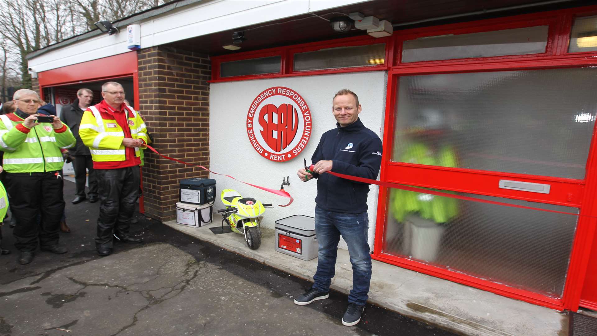 Shane cuts the ribbon outside the new HQ