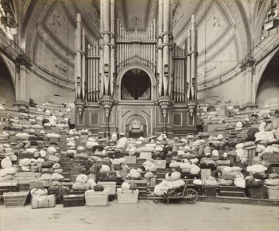 Belongings of refugees lying in front of the Alexandra Palace organ (Google Arts and Culture/Alexandra Palace archives/PA)