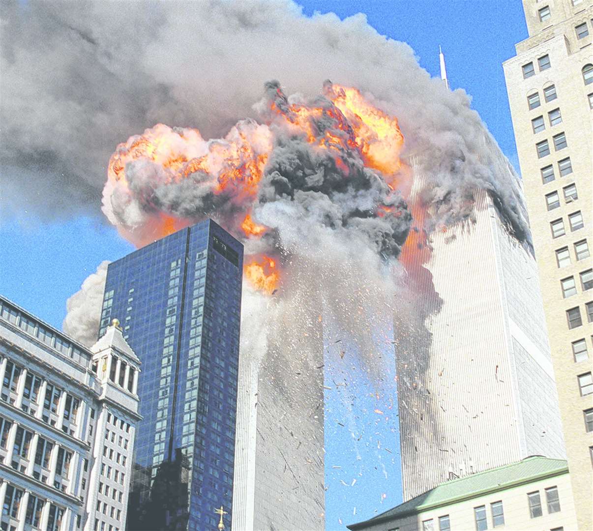 Smoke, flames and debris erupt from one of the World Trade Centre towers after a plane struck it on Tuesday, September 11, 2001. Picture: AP Photo/Chao Soi Cheong