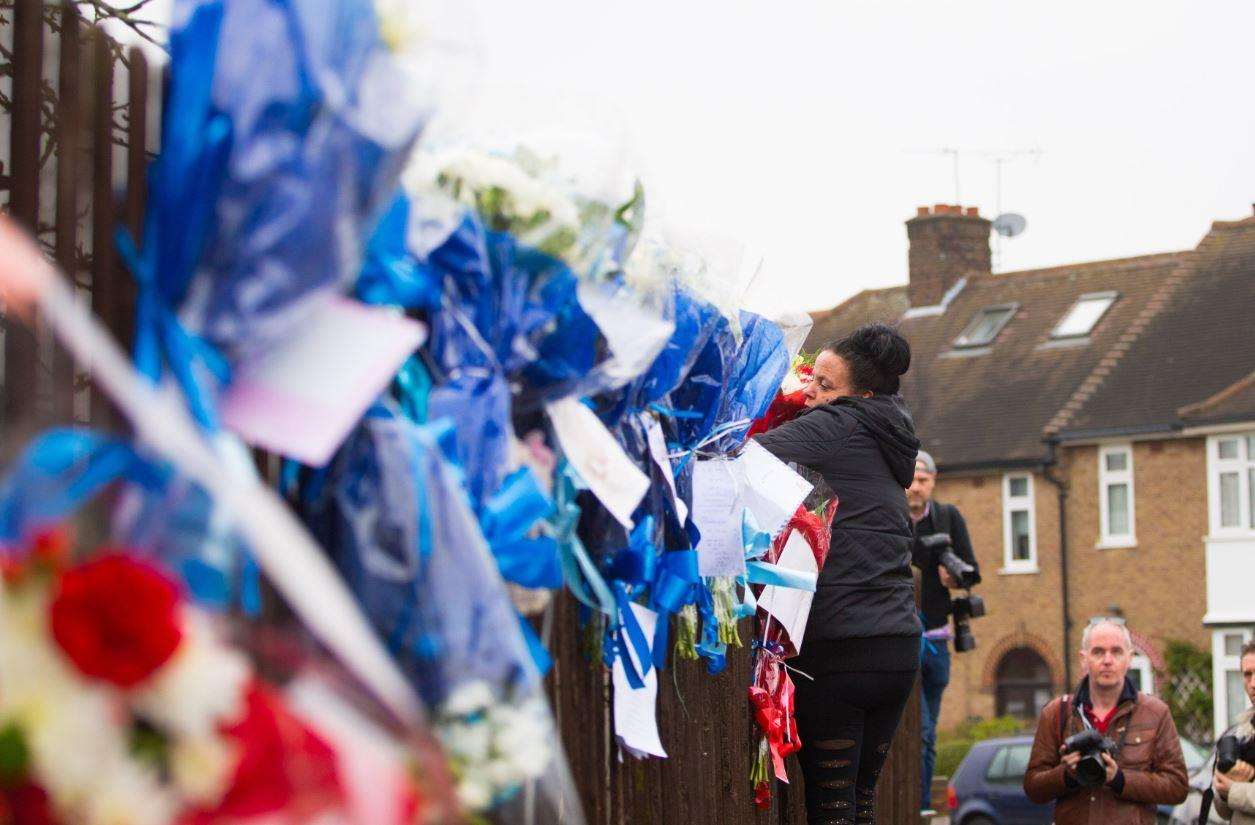 Flowers being attached to the fence yesterday afternoon. Picture SWNS