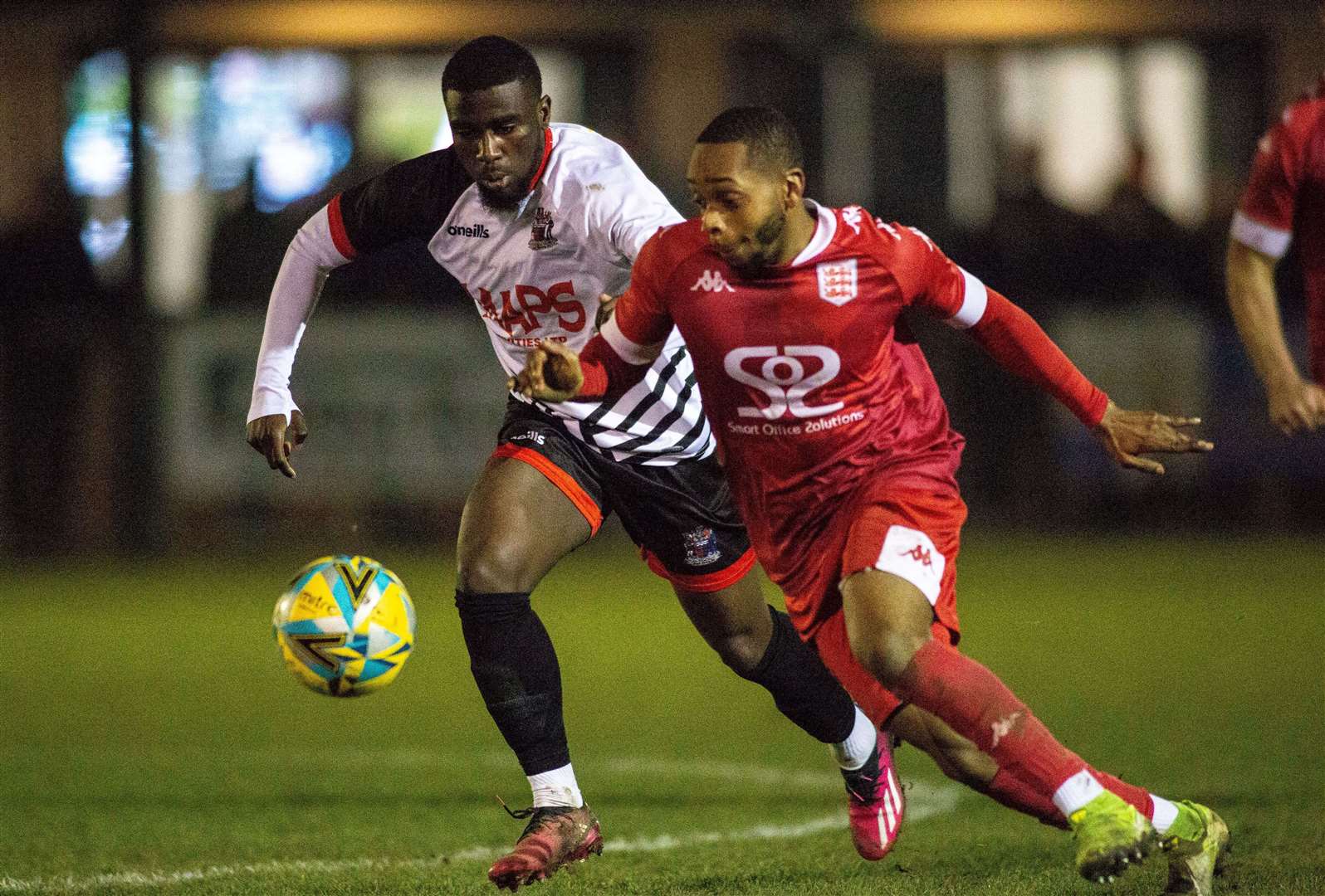 Deal's Ife Oni and Kieron Campbell, of Faversham, battle it out in midfield in Tuesday night’s 2-2 draw. Picture: Paul Willmott