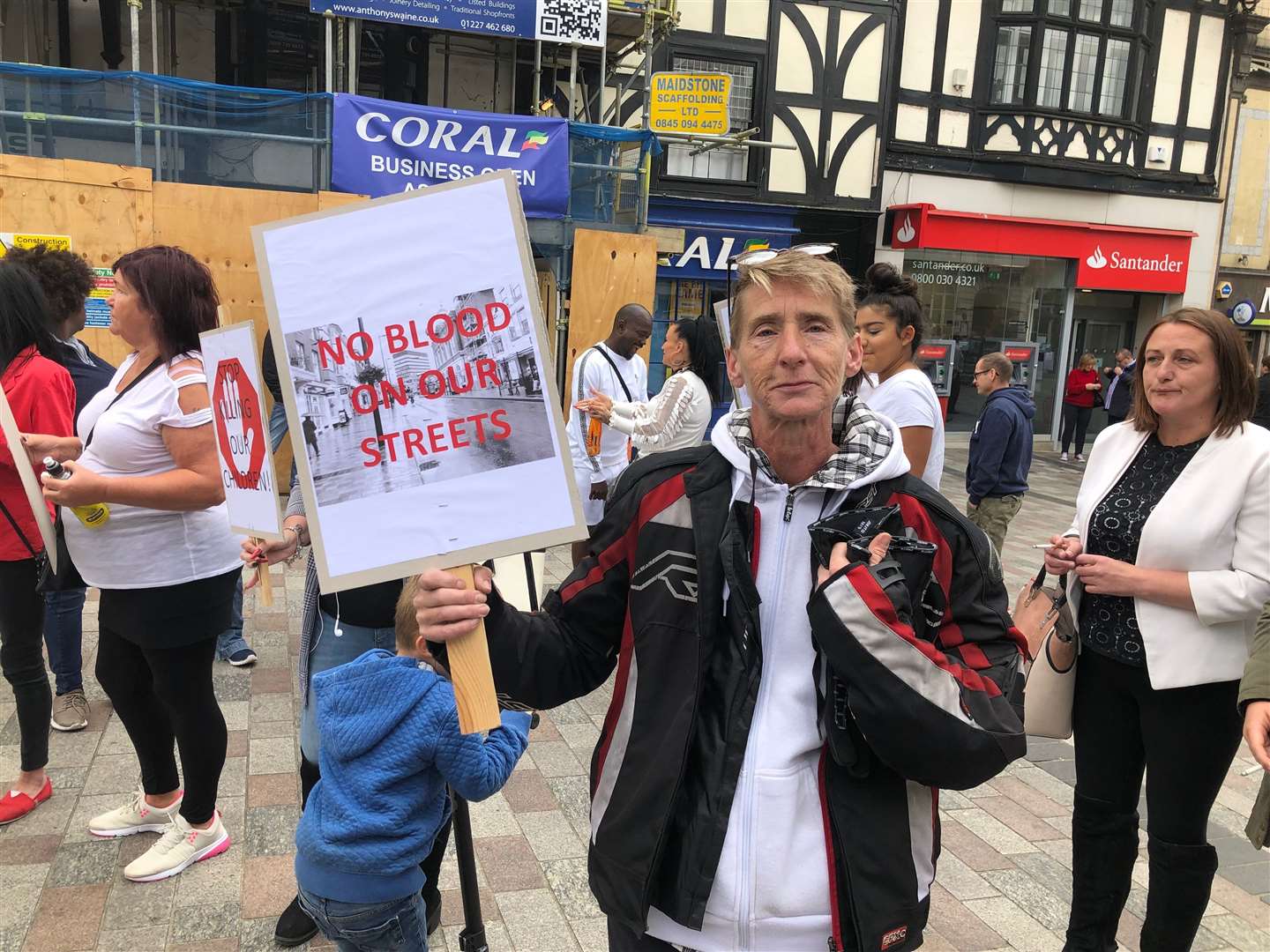 Lorraine Burns holds her sign high in the air (16243974)