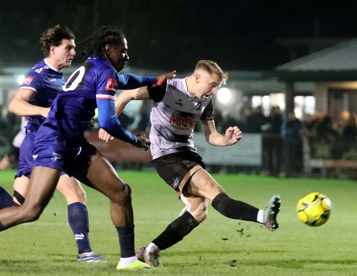 Tom Chapman fires wide for Deal under pressure from two Margate players. Picture: Paul Willmott