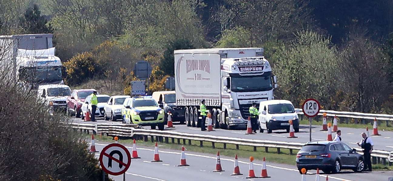 Gardai and PSNI officers mount armed coronavirus checkpoints on the border with Northern Ireland at Carrickarnon, Co Louth (Niall Carson/PA)