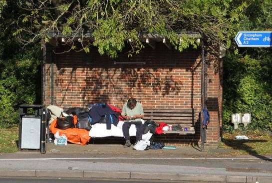 Jim camps out at bus shelter. Picture by Roger Vaughn