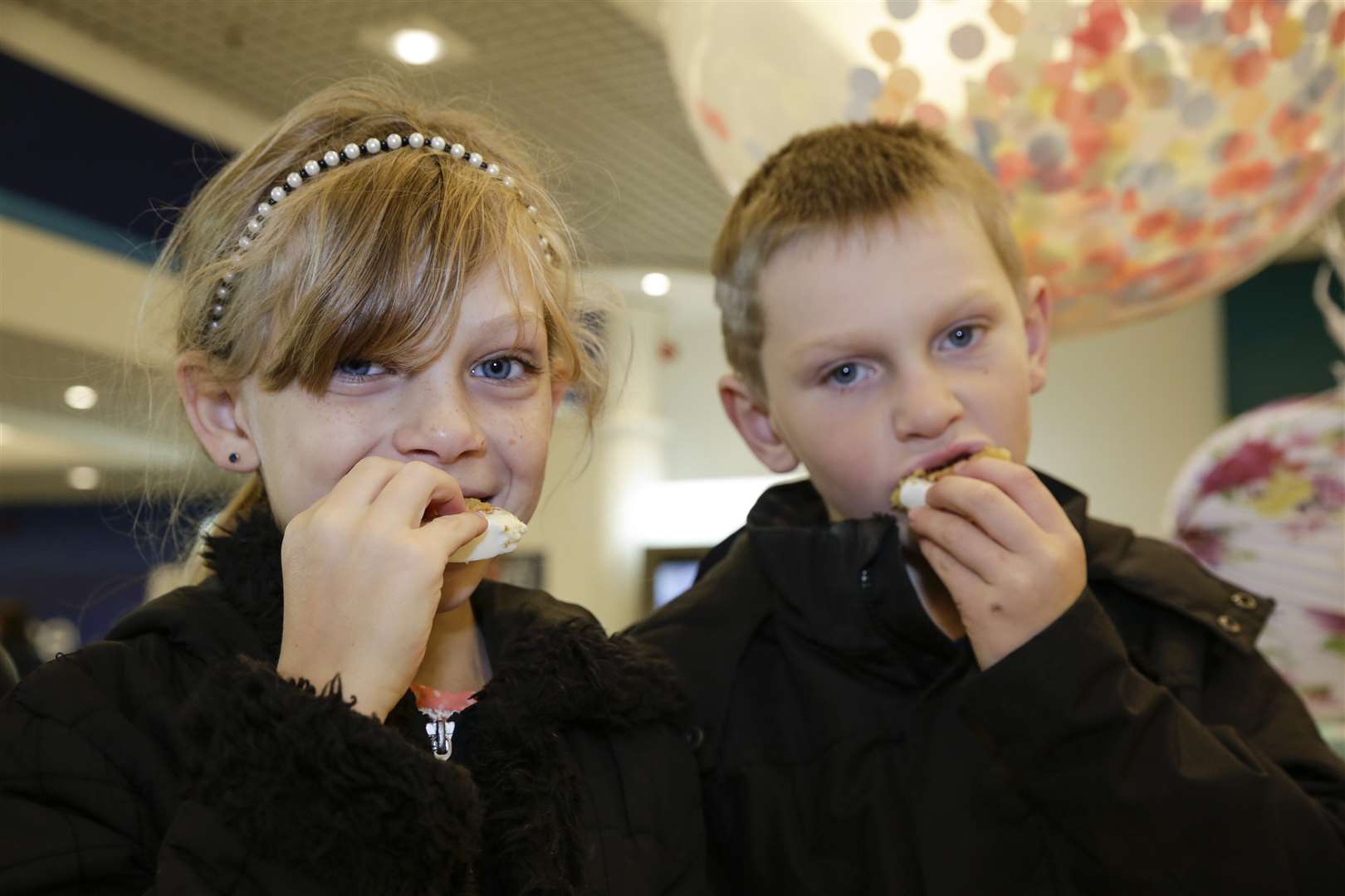 Phoebe Powsey and Leon Isaac enjoy some cake