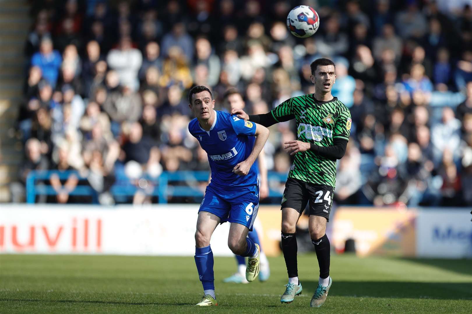 Gillingham captain Shaun Williams challenges Zain Westbrooke for the ball