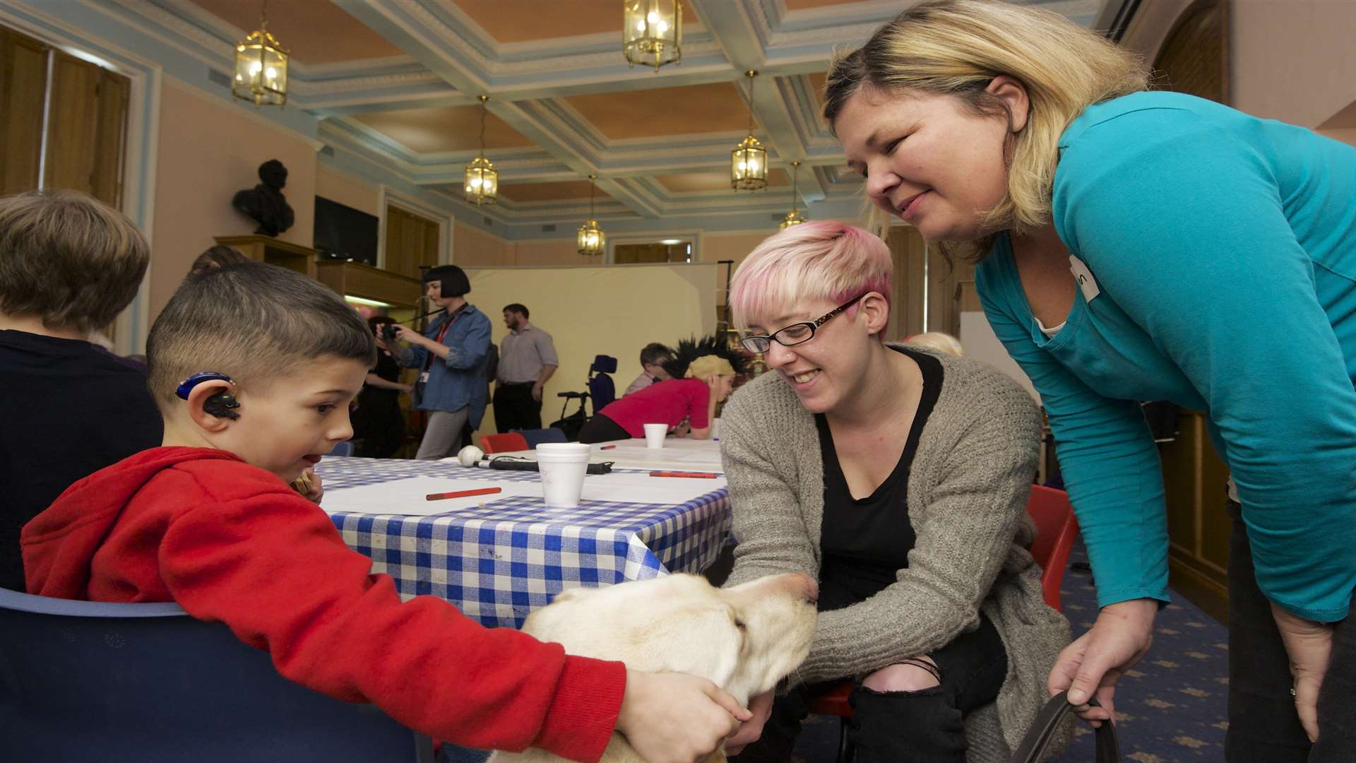 Oliver Smith, 6, and Natalie Smith meet Helen Wallis' guide dog, Rosie.