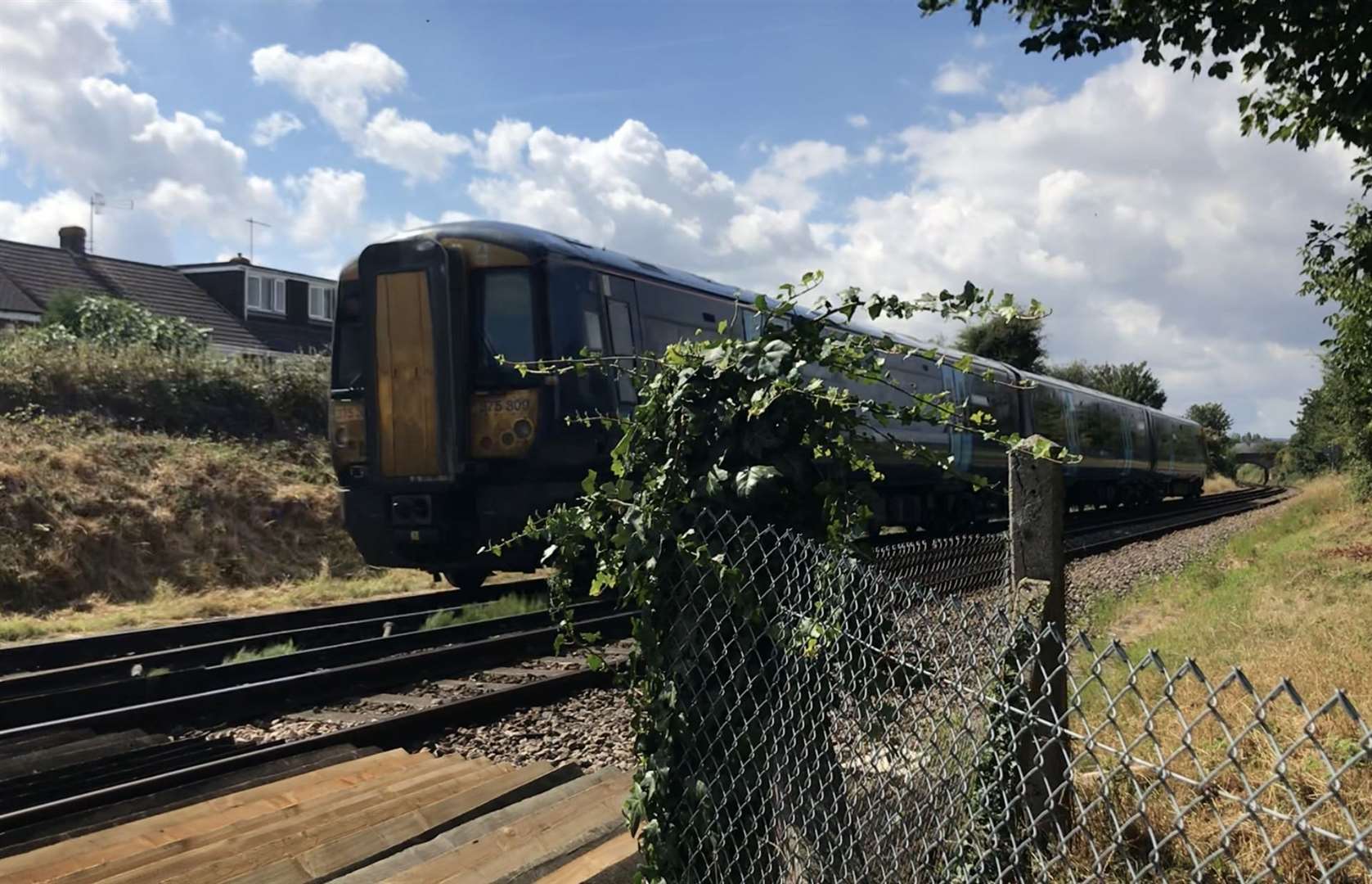 A train passing the pedestrian crossing between Volante Drive and Middletune Avenue in Milton Regis