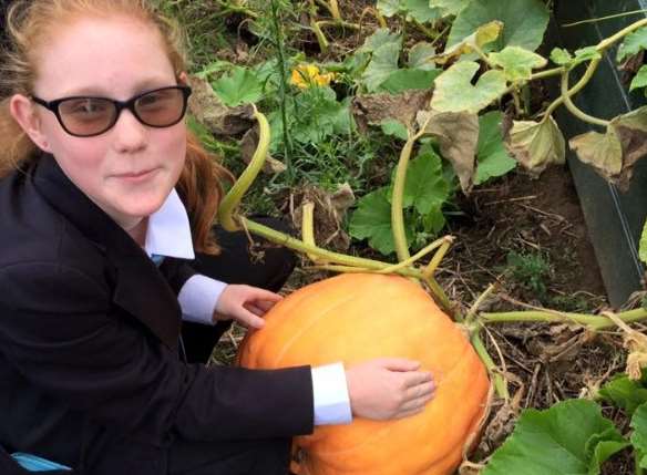 Lara, 14, helps with the gardening