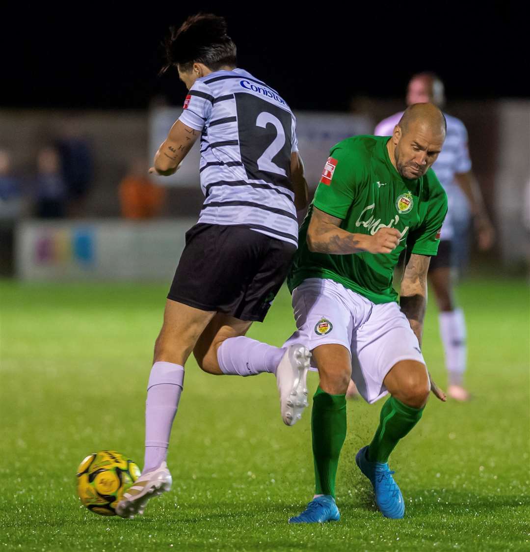 Ashford midfielder James Dunne battles with Margate defender Harrison Hatfull. Picture: Ian Scammell