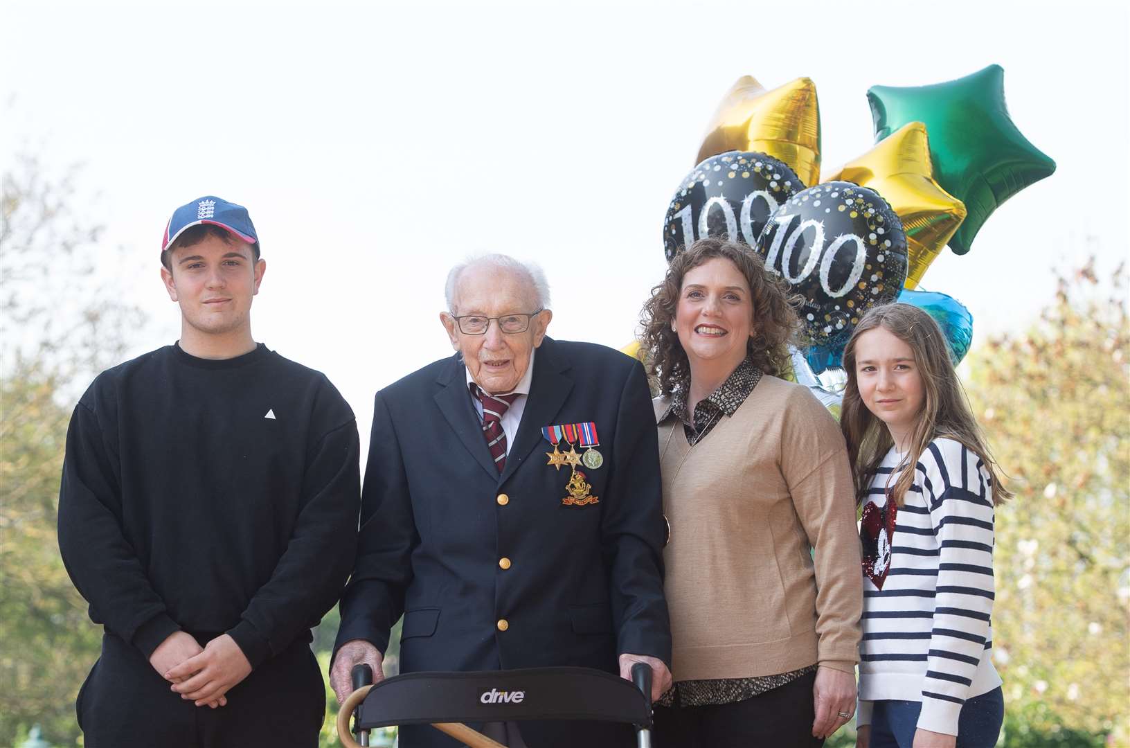 99-year-old war veteran Captain Tom Moore, with (left to right) grandson Benji, daughter Hannah Ingram-Moore and granddaughter Georgia (Joe Giddens/PA)