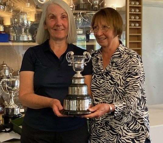 Three-time ladies' winner Julia Martin Harper, left, collects her trophy from KCPFA trustee Sue Barnes