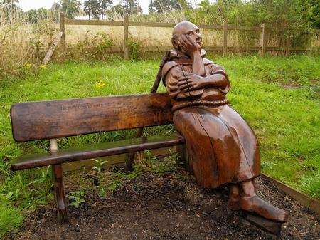 Percy the wooden pilgrim is lost in thought alongside the North Downs Way above Harrietsham