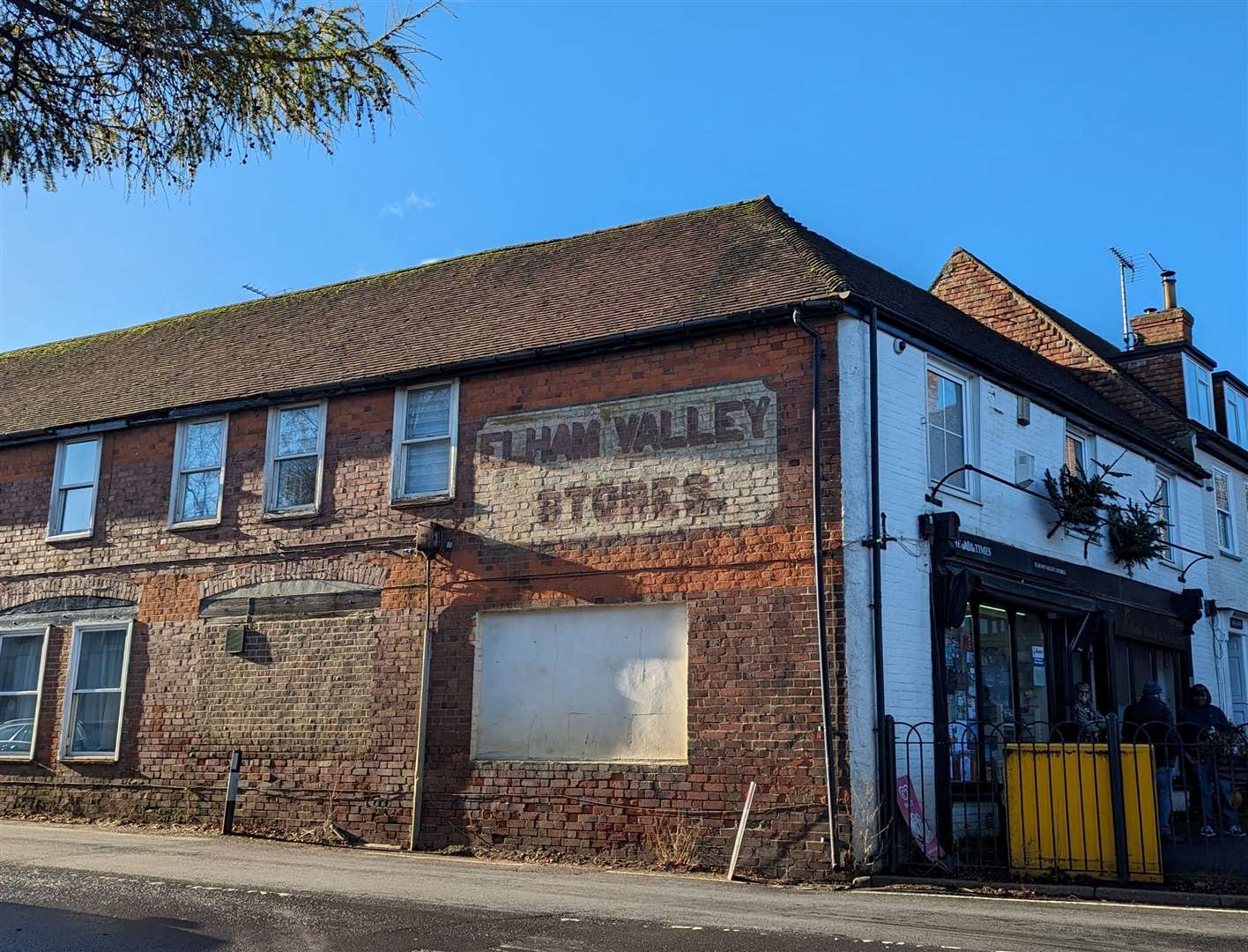 A faded sign on the side of the village shop in Elham