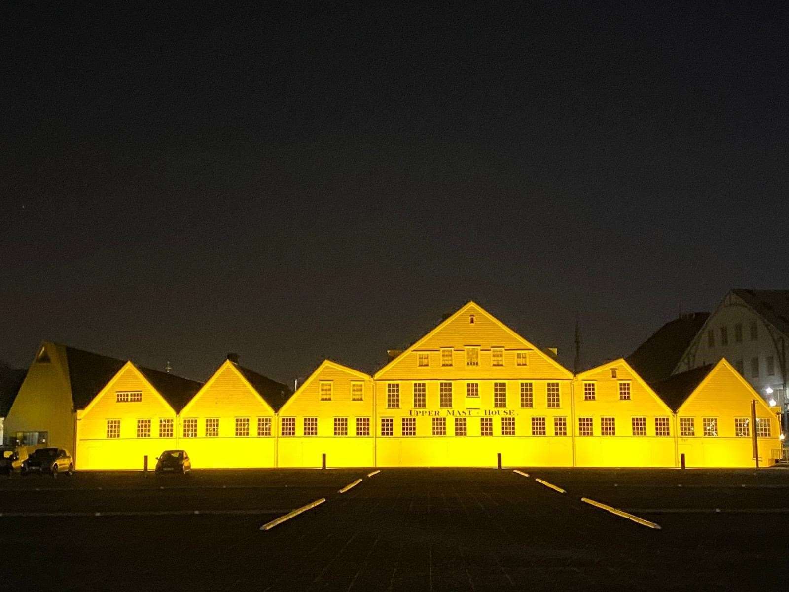 Chatham Dockyard Mast Houses lit up yellow on Reflection Day. Picture: Chatham Dockyard